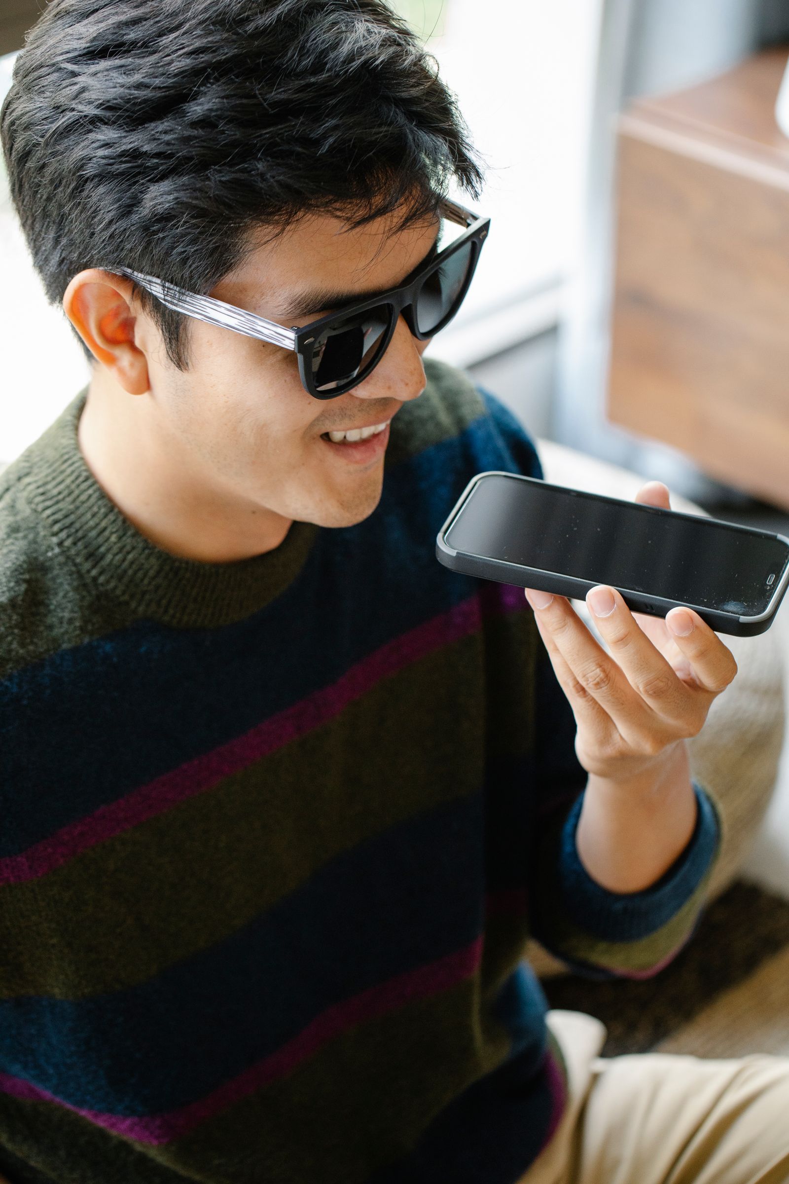 A participant speaking his answers into a phone during an AI-moderated interview